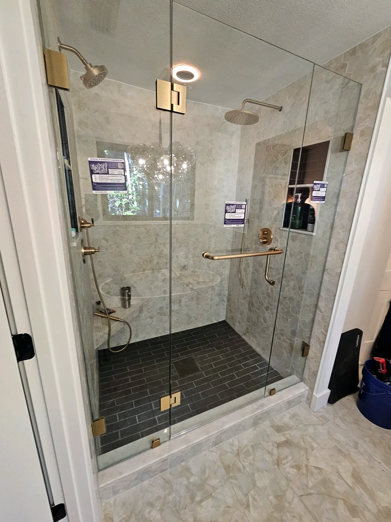 Dual showerhead gold hardware glass shower in Melbourne